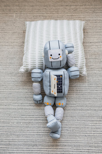 Wonder & Wise Tot Bot posing on a pillow.