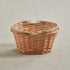 Sturdy wicker basket on a beige fabric background