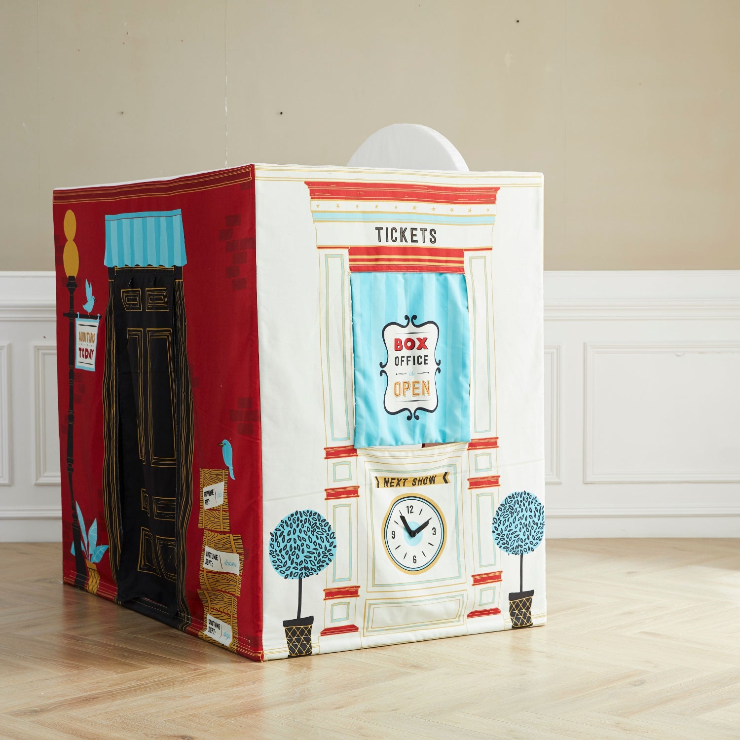 Children's playhouse with vintage ticket office design on a wooden floor.