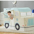 Child playing in cream and light blue ice cream truck playhouse with awning and windows