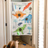Child playing with dinosaur doorway bean bag toss game featuring colorful dino graphics