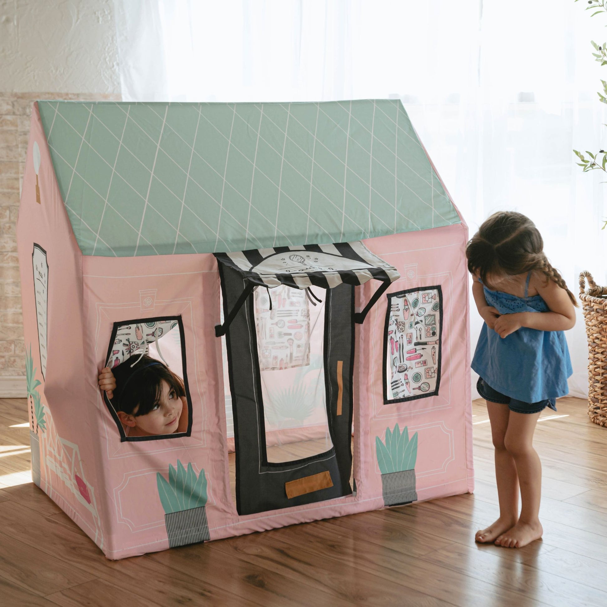 Kids play tent beauty salon with girl peeking through window opening