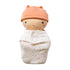 Bundle Baby Cookie doll with a peach knit cap and stitched face, swaddled in a white blanket with pink stars