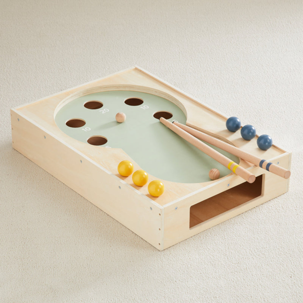 Cool Pool wooden tabletop pool game with sage green playfield, two cues and blue and yellow wooden balls on carpet