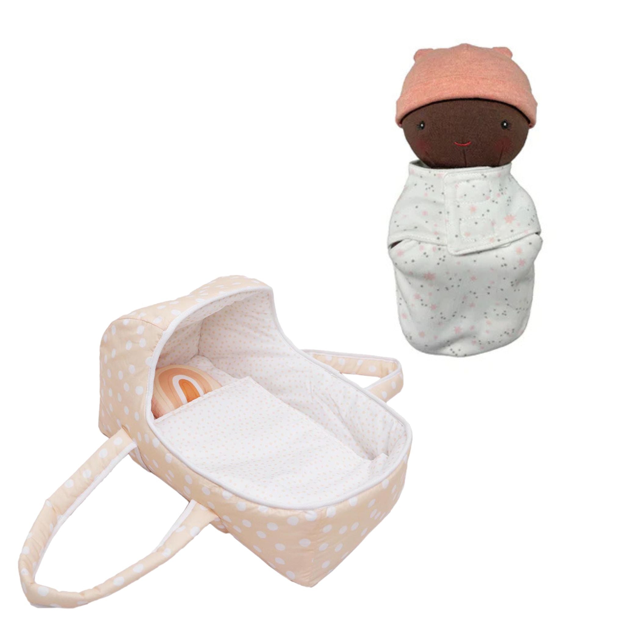 Dots and Rainbows Doll Carrier beside the swaddled Sweet Pea doll in a pink cap, on white
