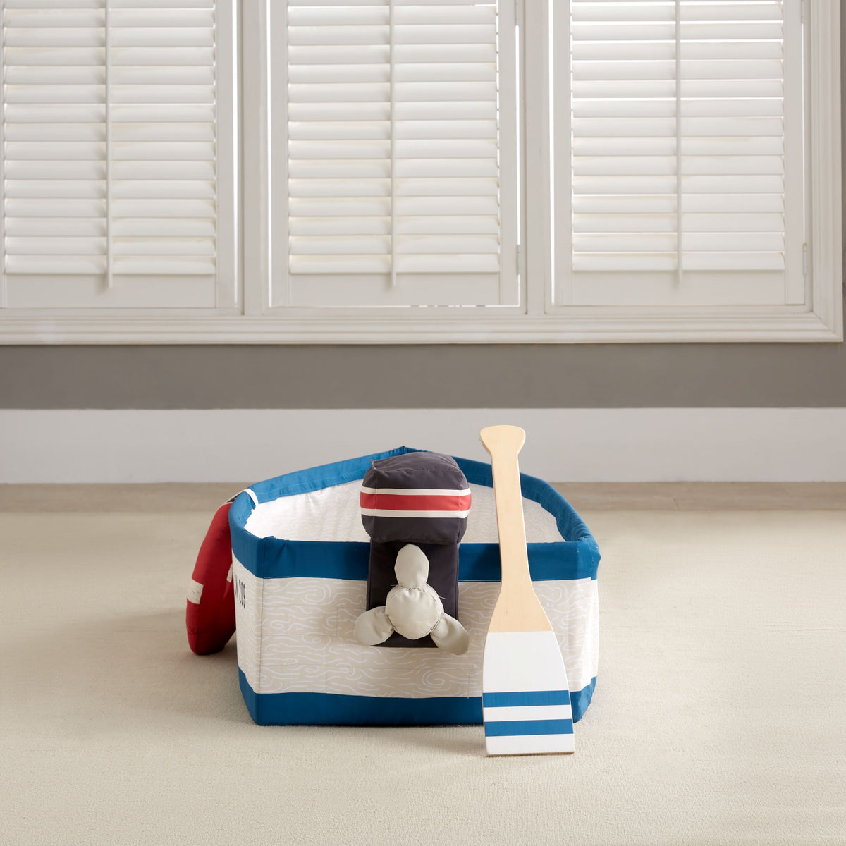 Gone Fishing Boat seen from the stern with the plush motor and striped wooden oar beneath shutters