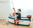 Two children fishing from the Gone Fishing Boat on a wood floor by a bright window