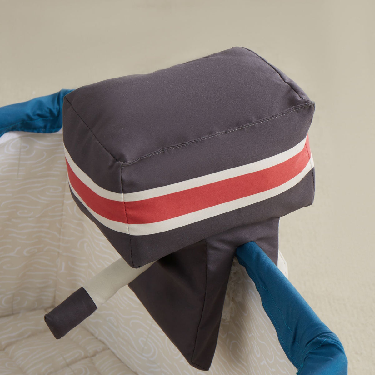 Close-up of the Gone Fishing Boat plush motor in charcoal with a red and white stripe
