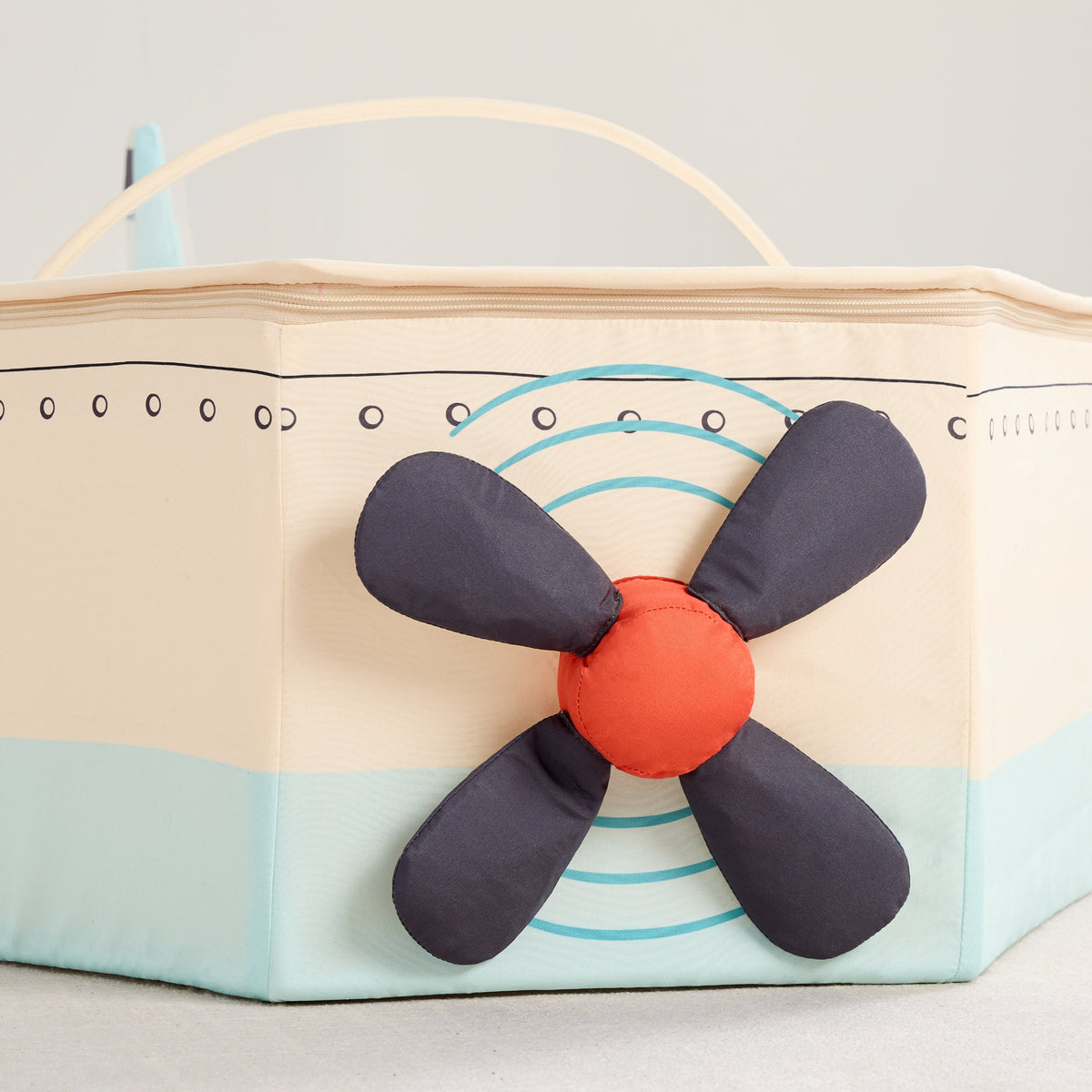 Close-up of the Gone Flying Airplane plush propeller in navy with a red center