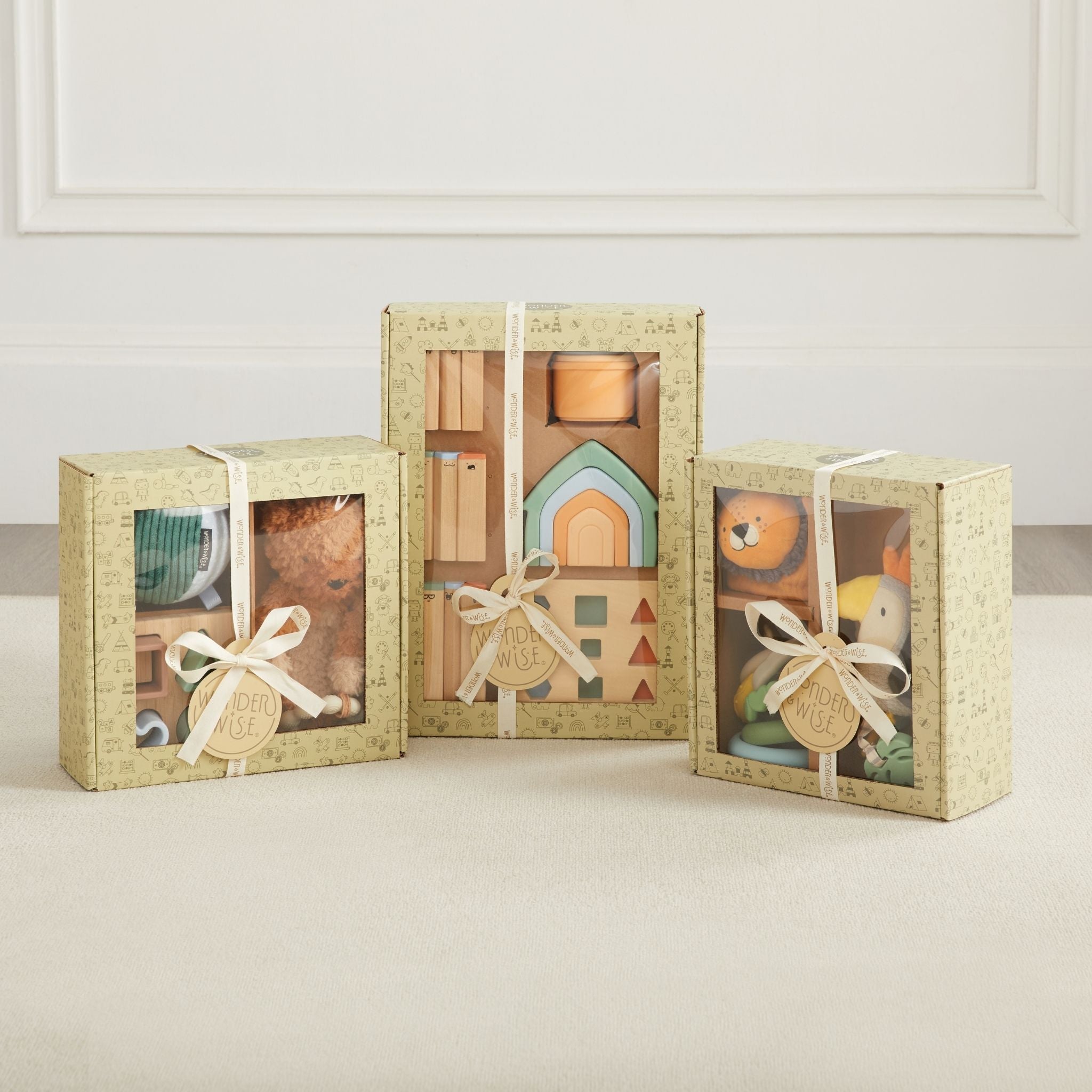 Three gift boxes containing toys on a neutral background
