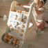 toddler pulling up on the baby activity walker