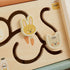 Wooden puzzle with animal shapes including a rabbit and a cat.

