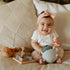 Happy baby playing with soft toys and wooden blocks from Hello Baby gift set for 6-9 months