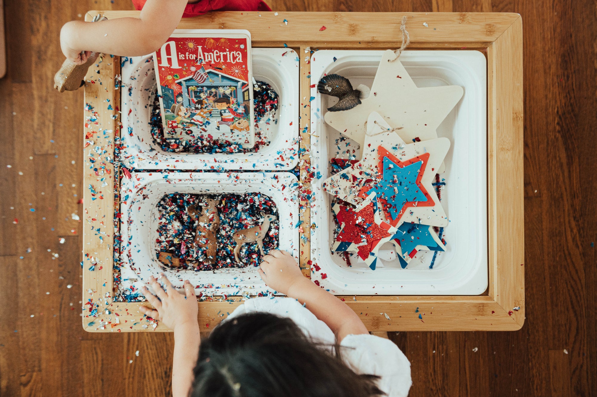 children playing with the land, sand and water table