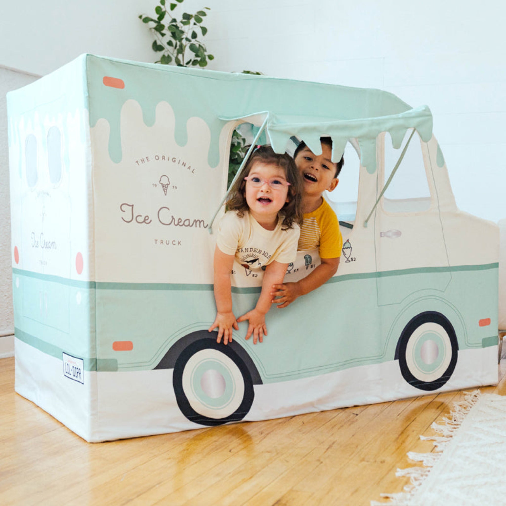 Kids playing in a Little Dipper ice cream truck toy playhouse